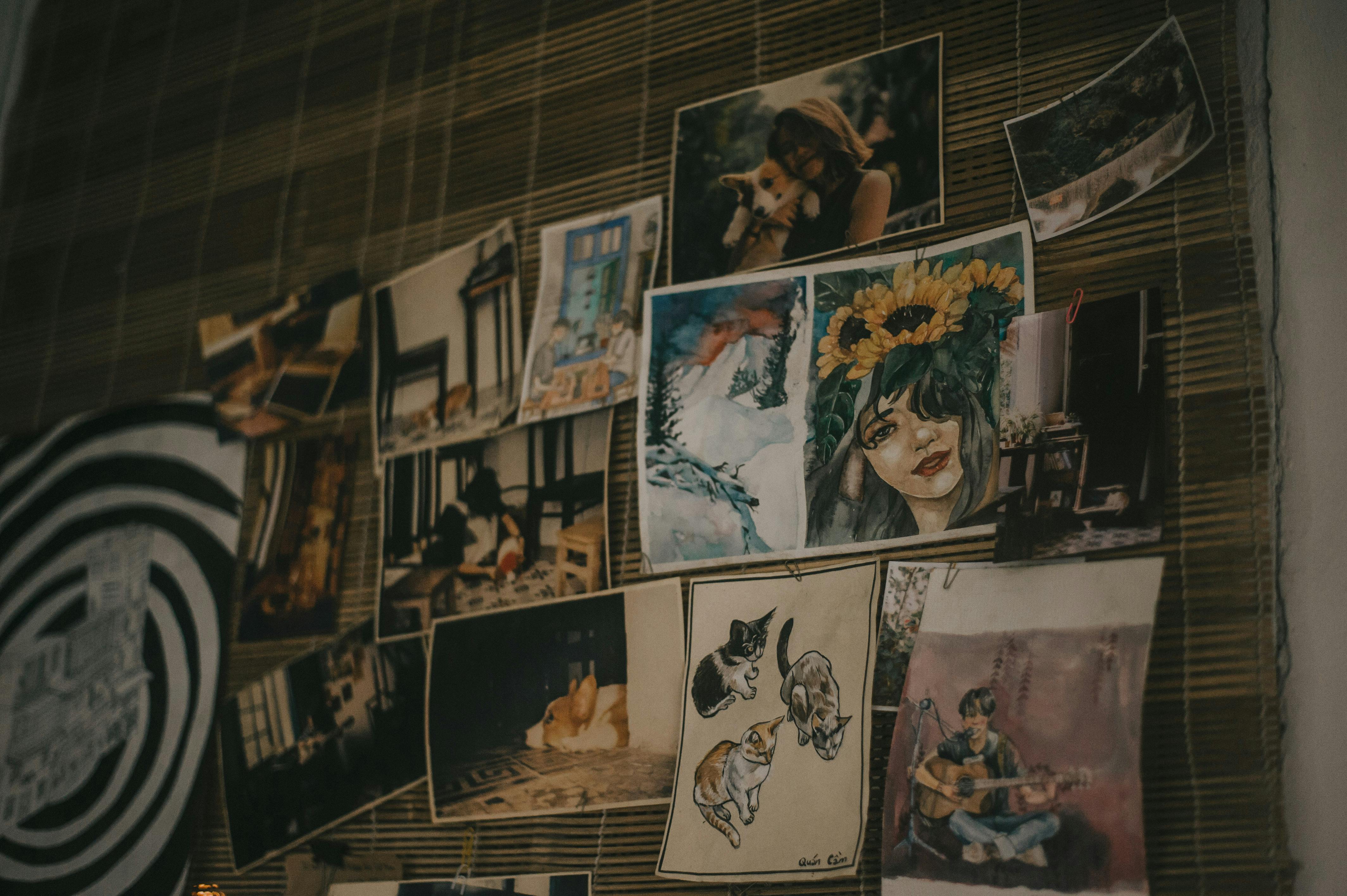 Gallery wall displaying student paintings and mixed media artwork